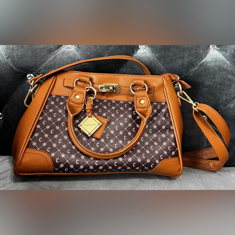 Gently used large brown personalized Charmaine purse trimmed in gold.